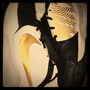 Kids gold, white and black nike shoes